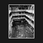 The crumbling interior of an abandoned hotel, with graffiti-covered walls and fractured surfaces, showcasing urban decay and raw desolation.